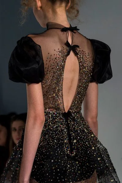 Woman wearing a custom black backless evening gown with sheer embellished details, showcasing bespoke formal wear for black tie events at From Collars to Cuffs in South Florida