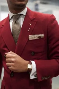Man wearing a custom-tailored red double-breasted suit with a matching pocket square and tie, showcasing bold luxury menswear and expert craftsmanship at From Collars to Cuffs in South Florida