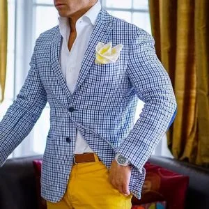 Man wearing a custom blue plaid blazer with yellow trousers and a yellow pocket square, showcasing stylish bespoke smart casual fashion at From Collars to Cuffs in Weston, South Florida
