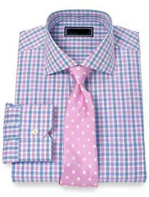 Folded custom pink and blue checkered dress shirt paired with a pink polka dot tie, showcasing premium fabric selection and bespoke shirt-tie combinations at From Collars to Cuffs in South Florida