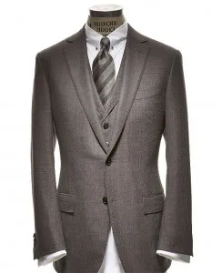 Mannequin displaying a custom-tailored grey 3-piece suit with vest and tie, highlighting expert formal craftsmanship and premium fabric selection at From Collars to Cuffs in Weston, Florida