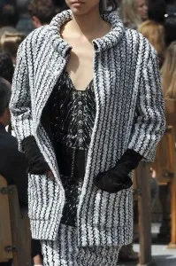 Model wearing a custom black and white striped bouclé jacket with wide collar and cuffs, showcasing high-end Chanel-inspired fashion and bespoke tailoring at From Collars to Cuffs in South Florida.