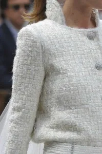 Close-up detail of a custom white tweed jacket with a high collar and textured fabric, showcasing premium craftsmanship, intricate stitching, and bespoke fashion at From Collars to Cuffs in South Florida.