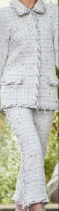 Woman in a custom white tweed suit featuring a classic collar jacket and matching pants, showcasing timeless Chanel-inspired bespoke tailoring at From Collars to Cuffs in Weston, Florida