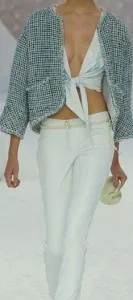 Model wearing a custom cropped tweed jacket over a white tied crop top and tailored white pants, showcasing chic bespoke resort wear and luxury tailoring at From Collars to Cuffs in Weston, South Florida