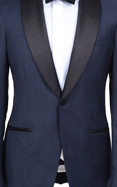 Back view of a custom navy tuxedo showing black satin lapels and precise tailoring details, demonstrating expert bespoke craftsmanship at From Collars to Cuffs in Weston, Florida.