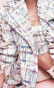 Close-up detail of a custom multi-colored tweed bouclé jacket with frayed edges and fringe, highlighting premium fabric textures and bespoke craftsmanship at From Collars to Cuffs in Florida