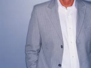 Man wearing a custom light grey textured blazer over a crisp white shirt, showcasing versatile bespoke business casual styling at From Collars to Cuffs in Weston, South Florida
