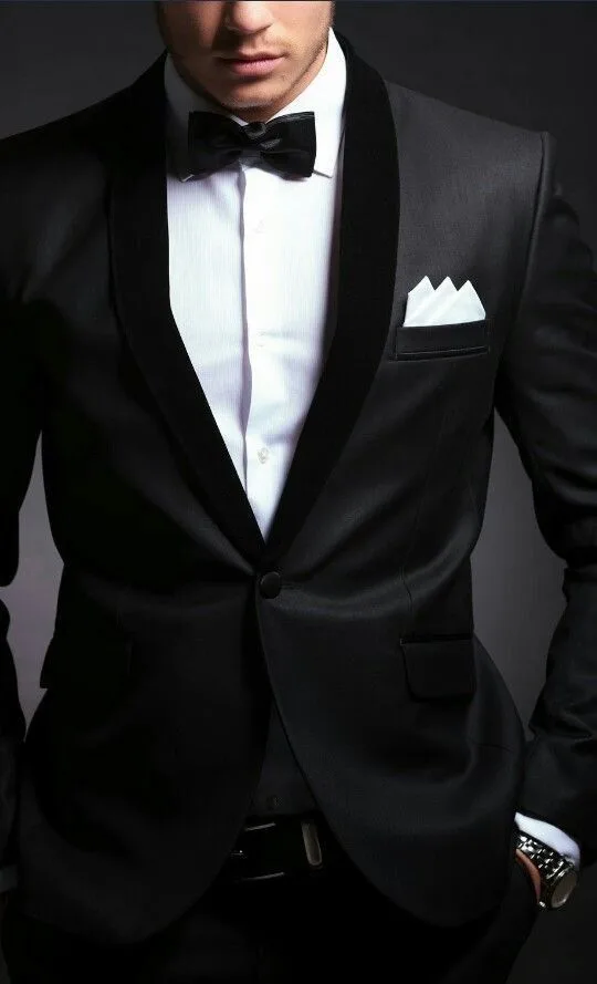 Man in a custom black tuxedo with black bow tie and white pocket square, showcasing expert tailoring for formal black tie events at From Collars to Cuffs in South Florida