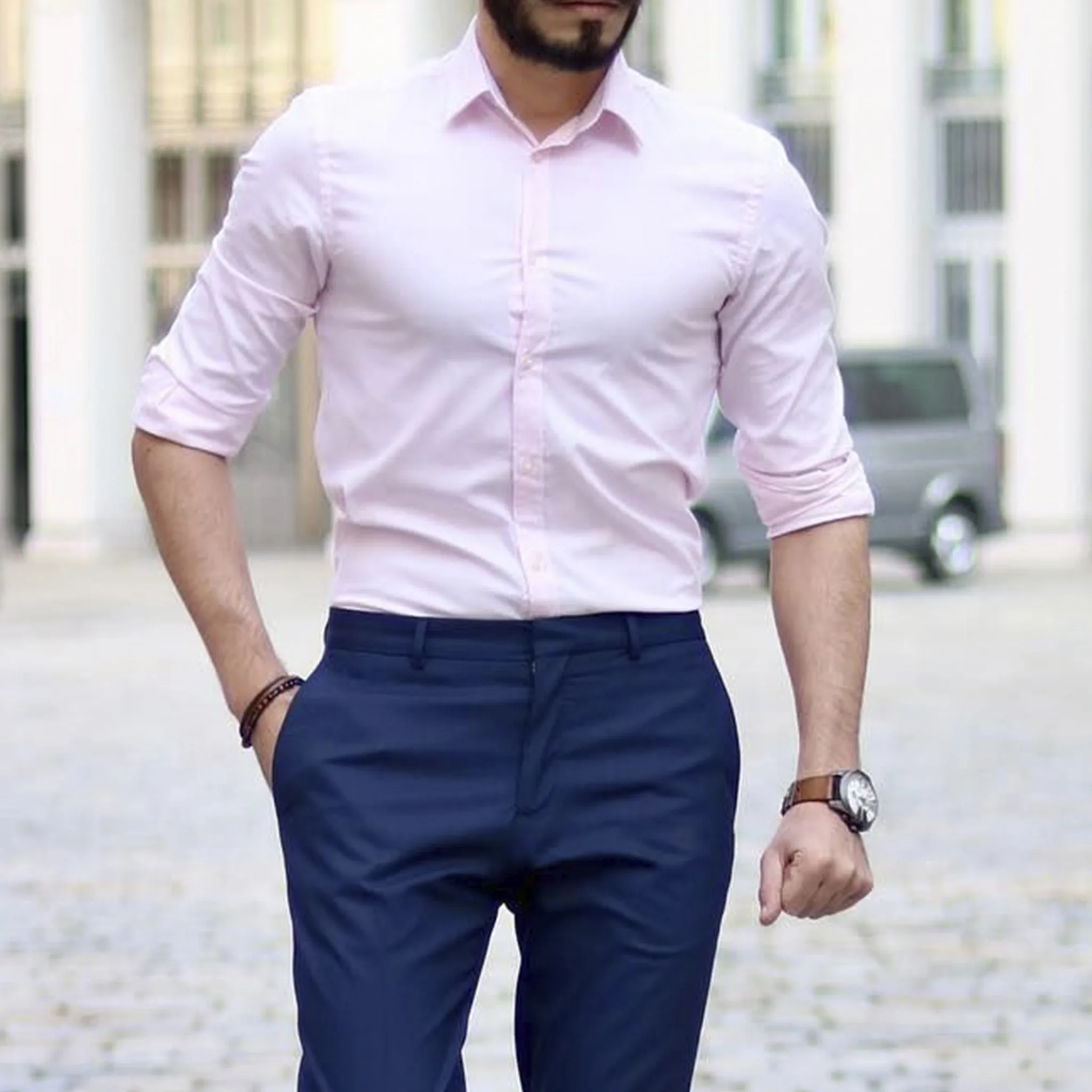 Man wearing a custom pink dress shirt and navy blue trousers, highlighting bespoke tailoring and custom fit at From Collars to Cuffs boutique in South Florida