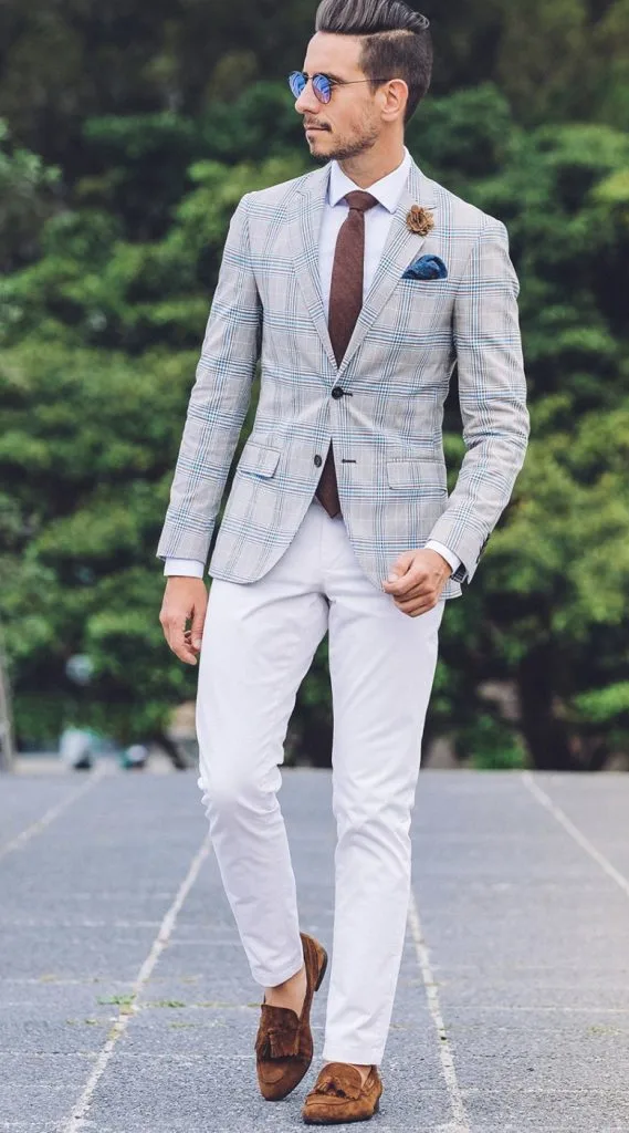 Man wearing a custom light grey plaid sport jacket with white dress pants and brown shoes, showcasing bespoke menswear crafted from premium Italian and French fabrics at From Collars to Cuffs in Weston, South Florida