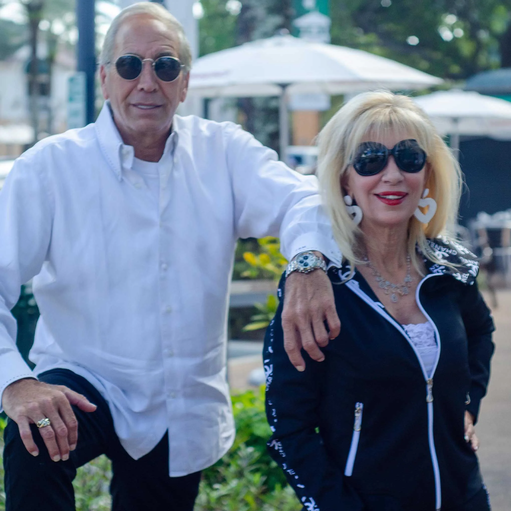 Beth Raymond founder of From Collars to Cuffs wearing a custom black hoodie with white detailing alongside a client in a white shirt, showcasing personalized casual fashion and client relationships in Weston Town Center, South Florida