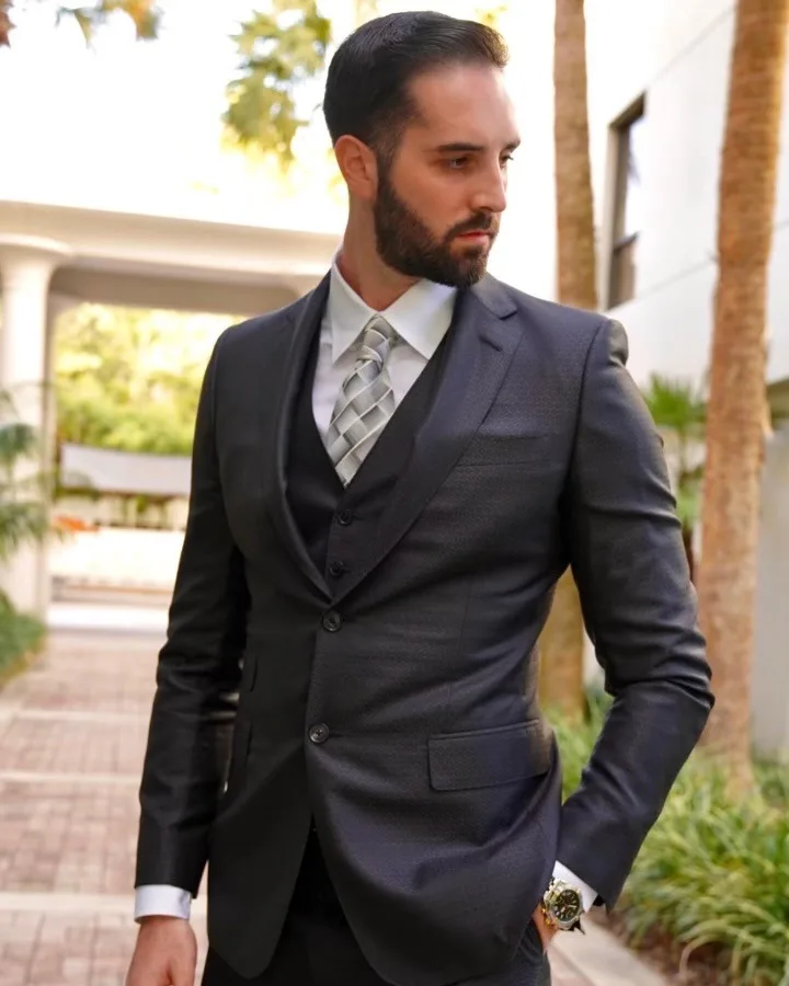 Man wearing custom charcoal 3-piece suit with personalized monogrammed lining, showcasing bespoke tailoring craftsmanship at From Collars to Cuffs in Weston, South Florida