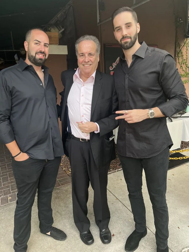 Men in custom black suits and formal attire, showcasing bespoke tailoring and perfect fit for special occasions at From Collars to Cuffs in Weston, South Florida